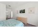 Comfortable bedroom featuring a wall mounted TV and an ensuite bathroom at 8103 Coconut Palm Way # 204, Kissimmee, FL 34747