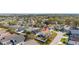 Birds-eye view of suburban homes featuring solar panels, driveways, and well-maintained landscaping at 919 Lake Charles Dr, Davenport, FL 33837