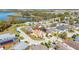 An aerial shot showcases a home with brown roof near a lake, enhanced by mature trees and green landscaping at 919 Lake Charles Dr, Davenport, FL 33837