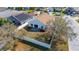 Aerial view of the home's fenced backyard featuring a well-maintained lawn and mature trees at 919 Lake Charles Dr, Davenport, FL 33837