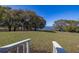 Backyard overlooking lake with stairs leading down from porch and surrounding trees at 919 Lake Charles Dr, Davenport, FL 33837