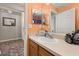Bright bathroom features a vanity and a mirror with toiletries at 919 Lake Charles Dr, Davenport, FL 33837