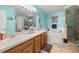 Bright bathroom boasts double sinks, a soaking tub, and a glass shower at 919 Lake Charles Dr, Davenport, FL 33837