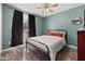 Bright bedroom features a window with curtains and a comfy bed at 919 Lake Charles Dr, Davenport, FL 33837
