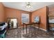 Bedroom featuring hard flooring, ceiling fan, a desk and a mirror at 919 Lake Charles Dr, Davenport, FL 33837