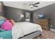 Well-lit bedroom features a ceiling fan, dresser, and cozy decor at 919 Lake Charles Dr, Davenport, FL 33837