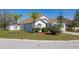 Landscaped front lawn featuring mature trees and hedges with a white-painted house at 919 Lake Charles Dr, Davenport, FL 33837