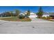 Attractive curb appeal featuring mature landscaping, shade trees, and a paved driveway at 919 Lake Charles Dr, Davenport, FL 33837
