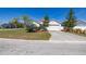 Charming single-story home with a two-car garage, well manicured lawn, and mature landscaping at 919 Lake Charles Dr, Davenport, FL 33837