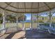 Interior view of community gazebo with benches overlooking serene lake and greenery at 919 Lake Charles Dr, Davenport, FL 33837