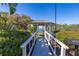 View from gazebo surrounded by bushes and leading to a lake at 919 Lake Charles Dr, Davenport, FL 33837