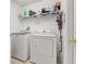 Laundry room with washer, dryer, wire shelving, and storage space for supplies at 919 Lake Charles Dr, Davenport, FL 33837