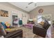 Open-concept living room with high ceilings, neutral walls, and colorful accents at 919 Lake Charles Dr, Davenport, FL 33837
