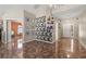Spacious living room featuring unique geometric wall art, tile floors, and access to other rooms at 919 Lake Charles Dr, Davenport, FL 33837
