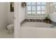 Bathroom with a large tub, tile accents, and natural light at 993 Everest, Clermont, FL 34711