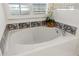 Bright bathroom features a large soaking tub with tiled walls and decorative accents at 993 Everest, Clermont, FL 34711