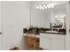 Bright bathroom features a vanity with mirror, granite counters, a sink, and storage at 993 Everest, Clermont, FL 34711