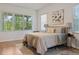 Bright bedroom features a comfortable bed, natural light, and a soothing neutral color palette at 993 Everest, Clermont, FL 34711