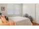 Cozy bedroom with a comfortable bed, a bright window, and a chair and pillows at 993 Everest, Clermont, FL 34711