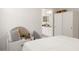 Comfortable bedroom with white bedding, accent pillows, and a view into the bright bathroom at 993 Everest, Clermont, FL 34711