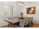 Dining room with wooden table, seating for eight, and a large window with shutters at 993 Everest, Clermont, FL 34711