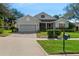 Charming one-story home featuring well-manicured lawn, brick driveway, and a welcoming front porch at 993 Everest, Clermont, FL 34711
