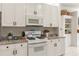 Bright kitchen features granite countertops, white cabinetry, and modern appliances at 993 Everest, Clermont, FL 34711