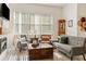 Bright living room featuring a fireplace, a window, and cozy, neutral-toned furniture at 993 Everest, Clermont, FL 34711