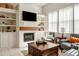 Stylish living room with a fireplace, built-in shelves, and comfortable seating area at 993 Everest, Clermont, FL 34711