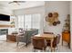 A living room blends with a dining area, featuring modern furnishings and abundant natural light at 993 Everest, Clermont, FL 34711