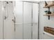Shower area with glass doors and a shower head and shelves on the right side at 993 Everest, Clermont, FL 34711