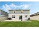 The backyard features a well-maintained lawn and a two-story home with a gray and white exterior at 1143 Seedorf Dr, Winter Haven, FL 33881