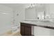 Bright bathroom features a granite countertop, vanity, and bathtub with shower at 1143 Seedorf Dr, Winter Haven, FL 33881