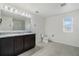 Large bathroom with granite vanity, dual sinks, and a glass enclosed shower at 1143 Seedorf Dr, Winter Haven, FL 33881