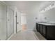 Bright bathroom featuring a glass-enclosed shower and double vanity with granite countertops at 1143 Seedorf Dr, Winter Haven, FL 33881