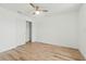 Bedroom featuring wood-look floors, ceiling fan, and closet with sliding doors at 1143 Seedorf Dr, Winter Haven, FL 33881