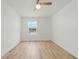 Bedroom featuring wood-look flooring, a ceiling fan, and a view from the window at 1143 Seedorf Dr, Winter Haven, FL 33881