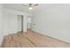 Bedroom featuring wood-look flooring, a ceiling fan, closet, and a connecting bathroom at 1143 Seedorf Dr, Winter Haven, FL 33881