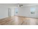 Bright Primary bedroom with wood floors, ceiling fan, and views from the double windows at 1143 Seedorf Dr, Winter Haven, FL 33881