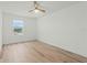 Bedroom featuring wood-look flooring, a ceiling fan, and a view from the window at 1143 Seedorf Dr, Winter Haven, FL 33881