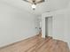 Bright bedroom with wood-look floors and a closet, leads to the bathroom at 1143 Seedorf Dr, Winter Haven, FL 33881