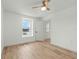 Bright bedroom with wood-look flooring, ceiling fan, and a view from the window at 1143 Seedorf Dr, Winter Haven, FL 33881