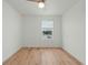 Bedroom features wood-look flooring, a ceiling fan, and a sunlit window at 1143 Seedorf Dr, Winter Haven, FL 33881
