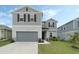 Charming two-story home with a well-maintained lawn and a two-car garage at 1143 Seedorf Dr, Winter Haven, FL 33881
