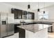 Modern kitchen with stainless steel appliances, dark cabinets, and granite countertops at 1143 Seedorf Dr, Winter Haven, FL 33881