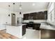 Stylish kitchen with stainless steel appliances, pendant lighting, and a center island at 1143 Seedorf Dr, Winter Haven, FL 33881