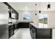Modern kitchen featuring dark cabinets, stainless steel appliances, and granite countertops at 1143 Seedorf Dr, Winter Haven, FL 33881