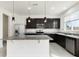 Beautiful kitchen with stainless appliances, dark cabinetry, granite countertops, and pendant lights at 1143 Seedorf Dr, Winter Haven, FL 33881