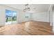 Bright, open living room featuring hardwood floors and sliding glass doors to the backyard at 1143 Seedorf Dr, Winter Haven, FL 33881