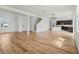 Spacious living room with hardwood floors leads to an open kitchen and a staircase at 1143 Seedorf Dr, Winter Haven, FL 33881